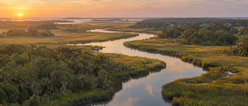 Illustrative photo: a Lowcountry salt marsh and tidal creek at golden hour